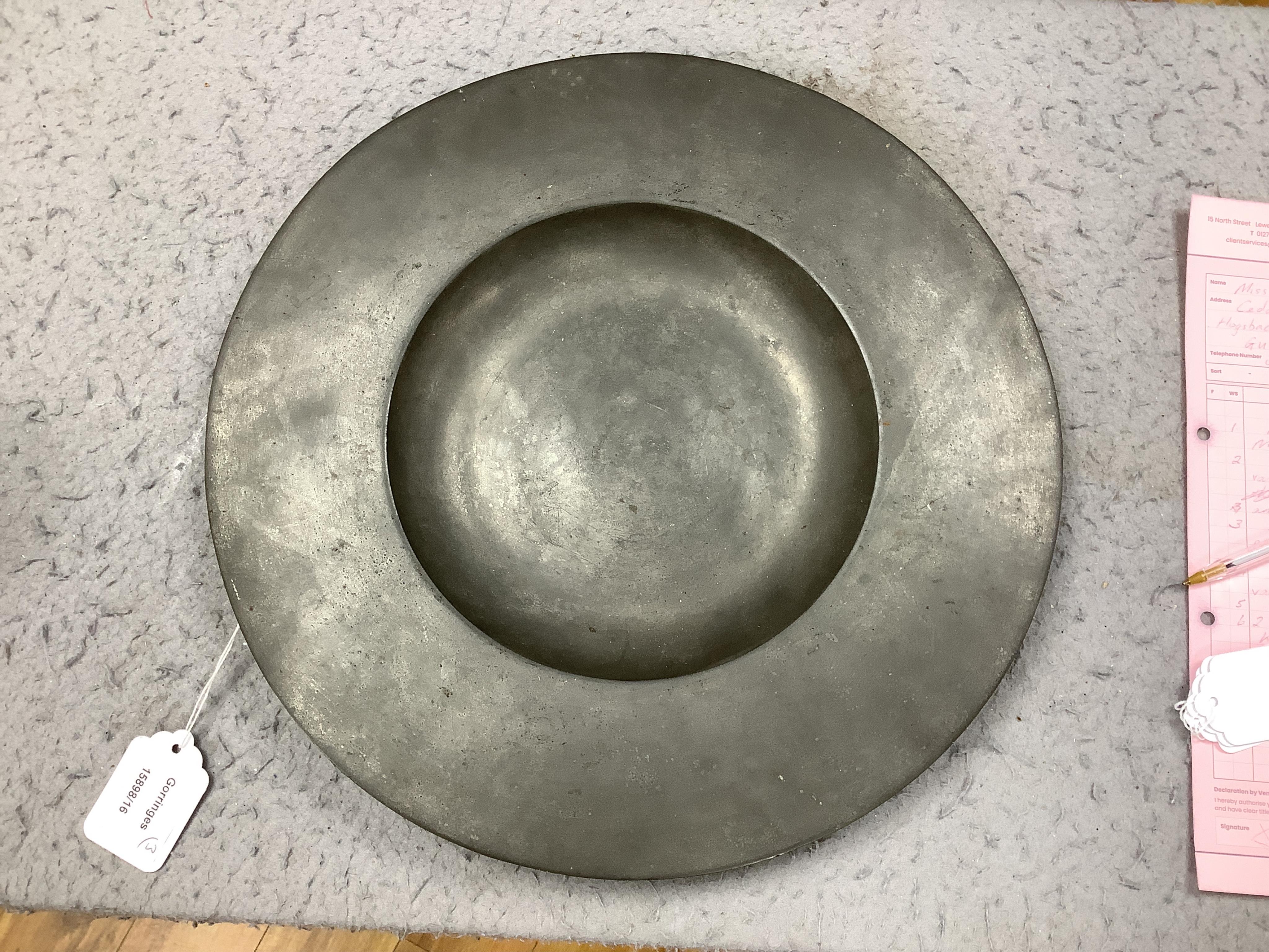 Three pewter chargers, a London touch mark to one, another with rubbed touch marks and ‘WRM’, and another with remains of a touch mark, largest 42.5cm diameter. Condition - fair, worn with damage to one